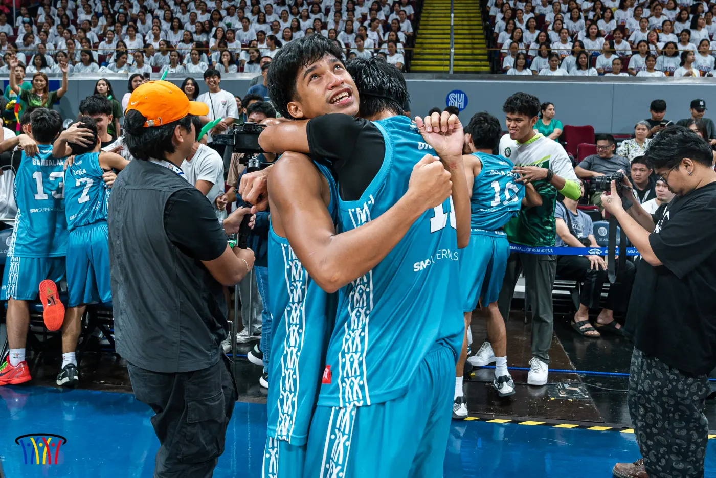 St. Jude College–Dasmariñas players embrace after winning the Division 2 title