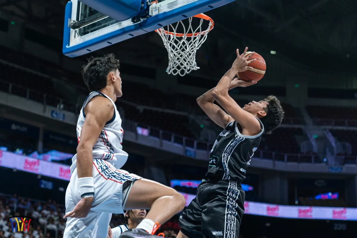 A Phenom BlueFire–Pasay player finishes at the rim