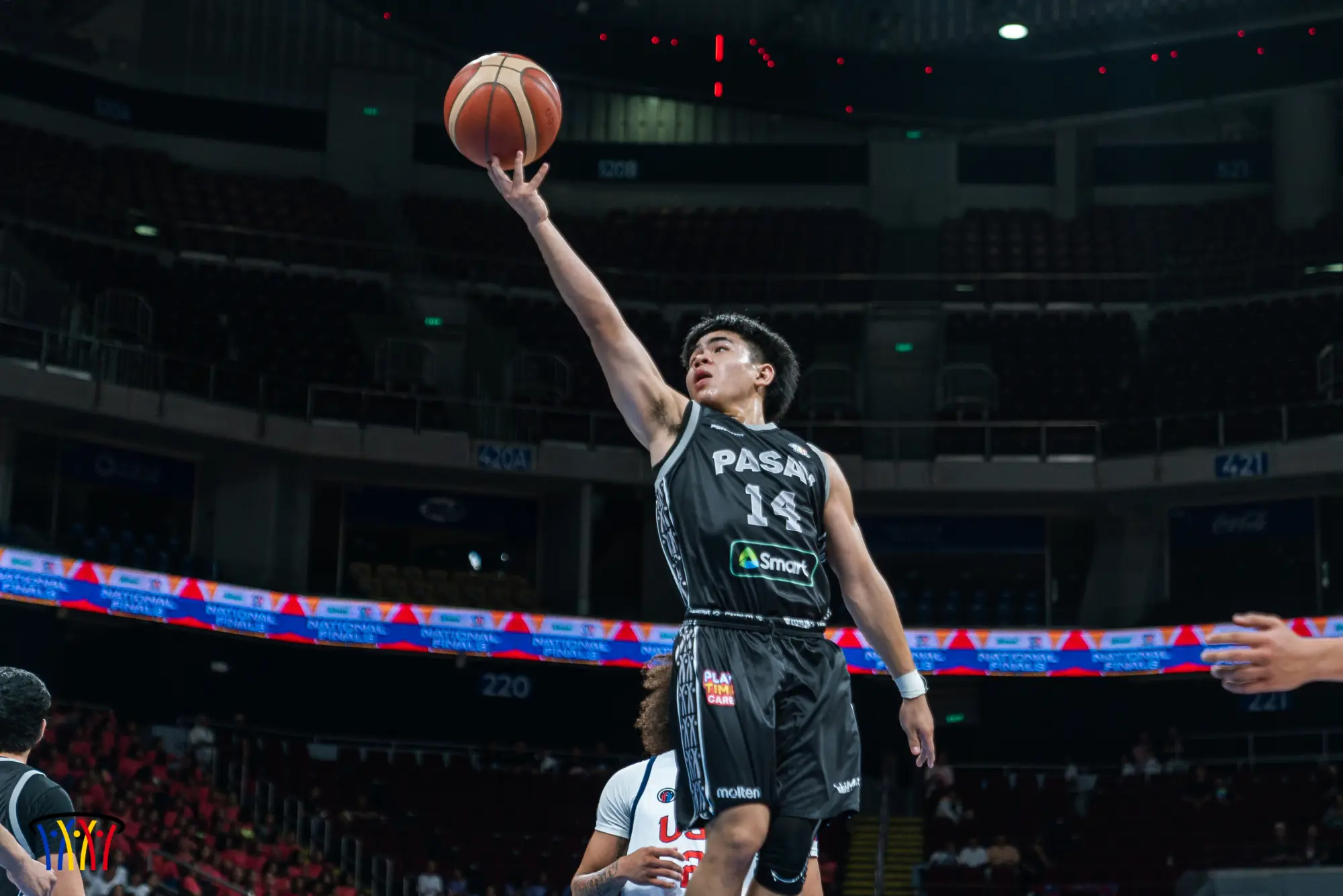A Phenom BlueFire–Pasay guard attacks the rim during the NBTC National Finals at the Mall of Asia Arena